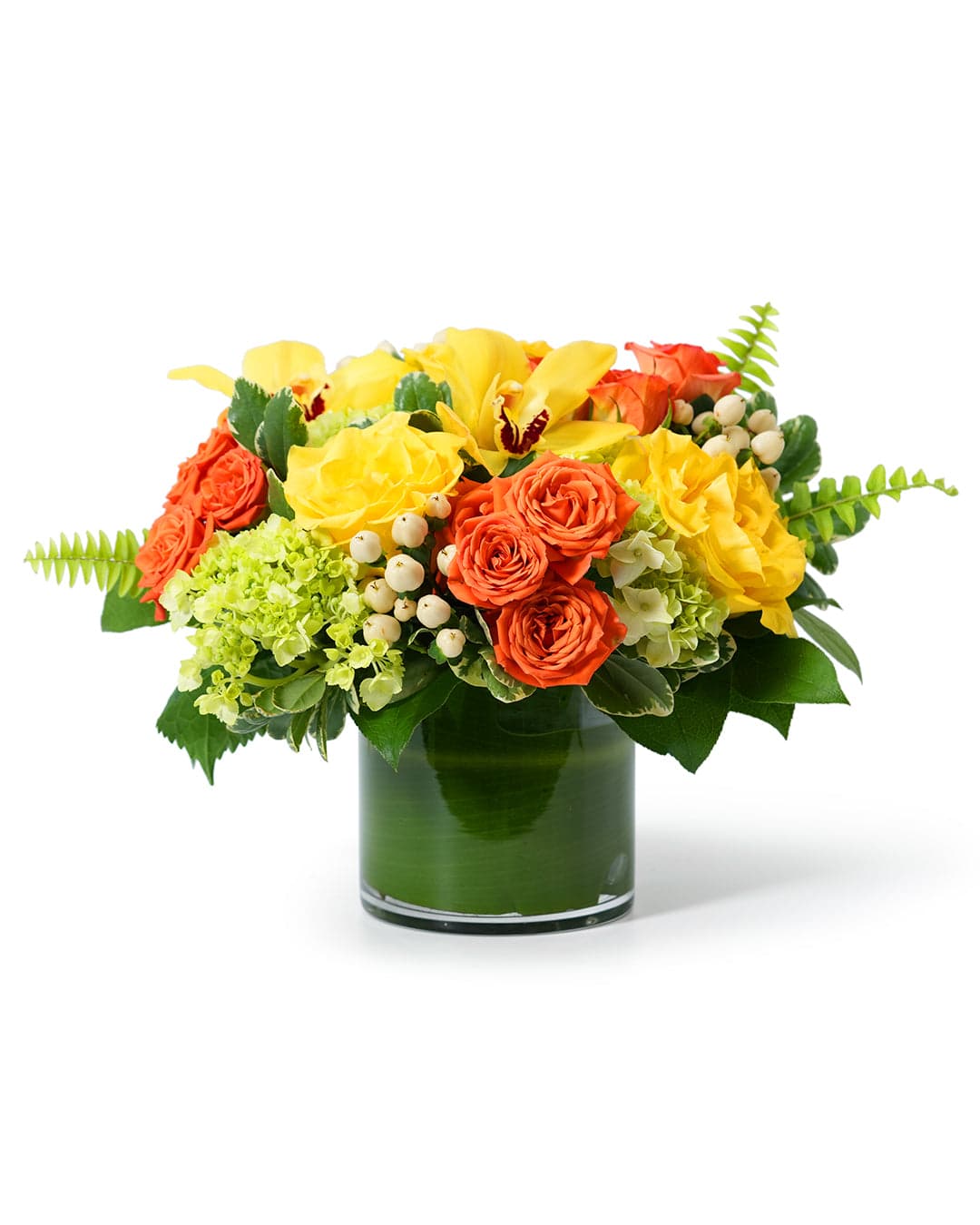 Vibrant floral arrangement featuring yellow roses, orange blooms, and green accents in a sleek glass vase.