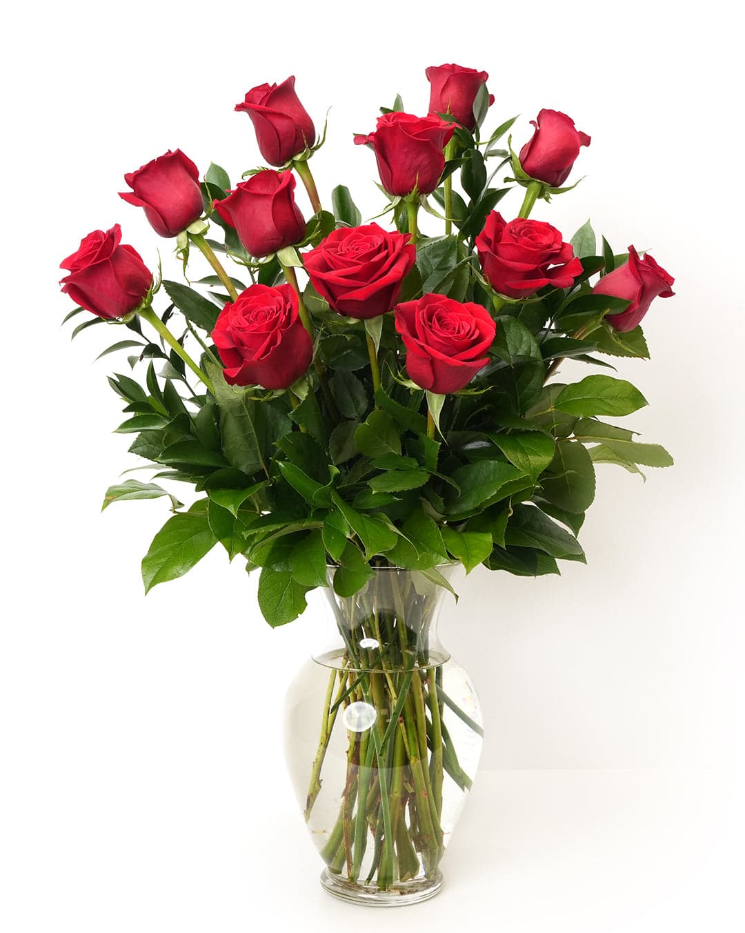 A beautiful bouquet of 12 classic red roses arranged in a glass vase, perfect for any special occasion.