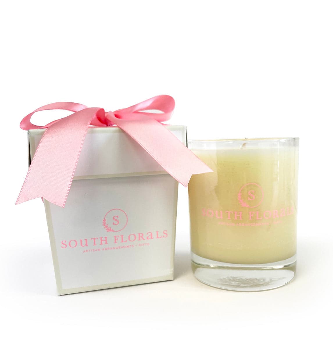Luxurious South Florals candle in a glass jar, beautifully packaged with a pink ribbon for a fragrant gift.