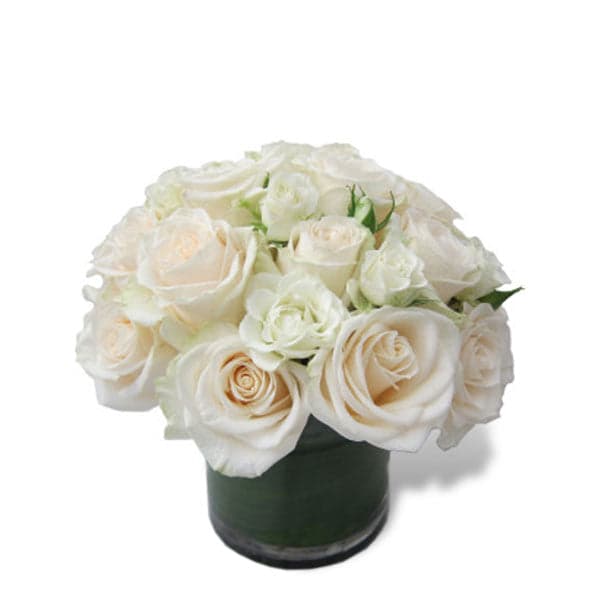 Elegant white rose bouquet in a sleek glass vase, perfect for any occasion or as a thoughtful gift.