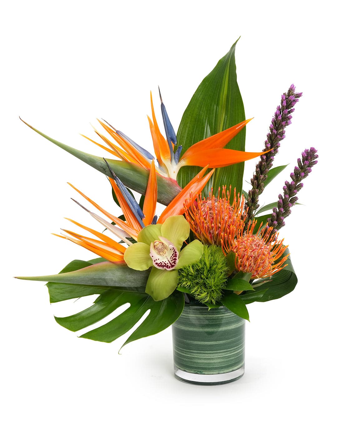 Vibrant tropical flower arrangement featuring bird of paradise, orchids, and lush green foliage in a stylish vase.