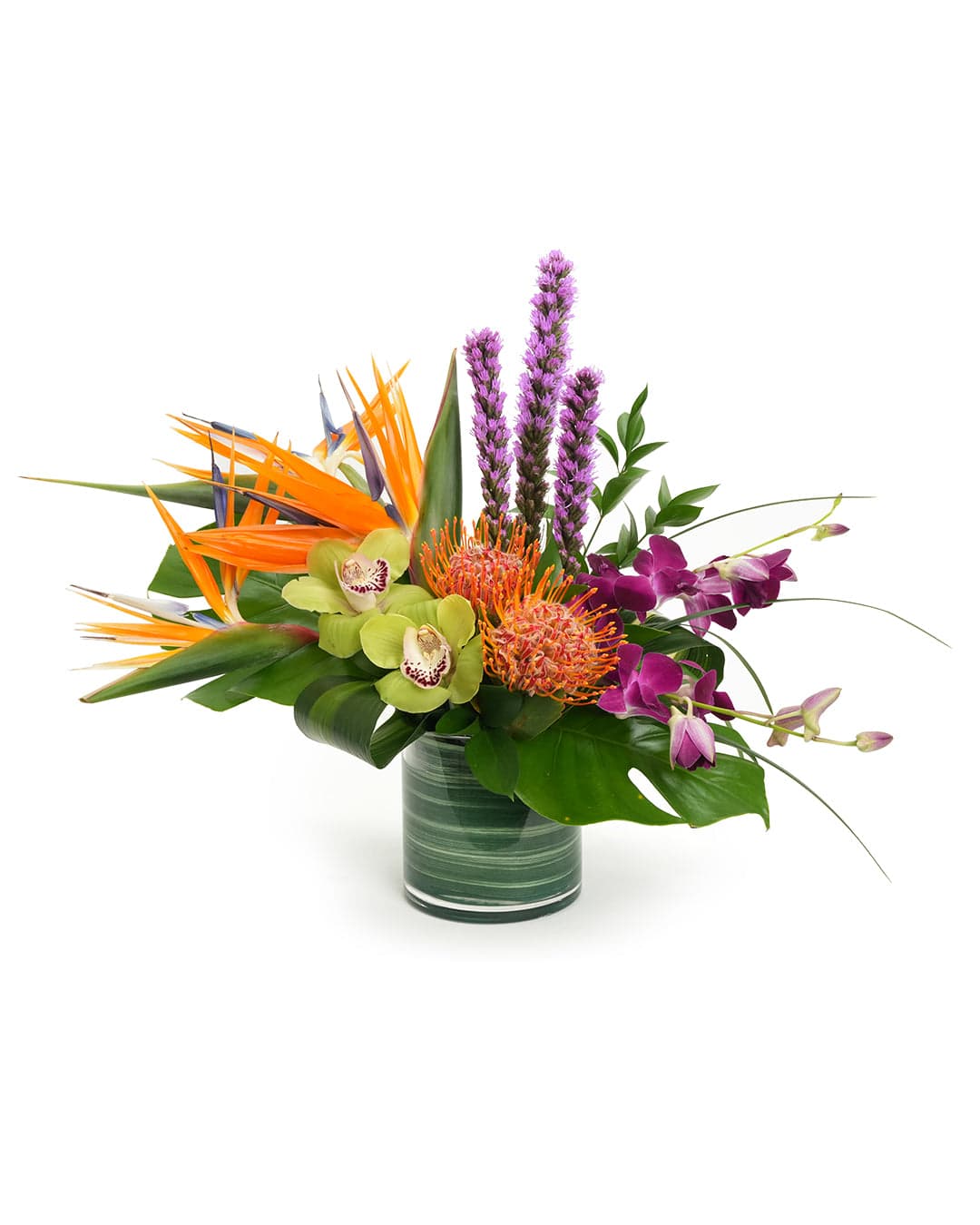 Vibrant tropical floral arrangement featuring orchids, protea, and heliconia in a stylish glass vase.